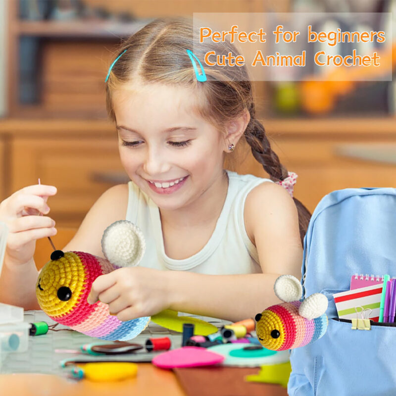 Small crochet rainbow bee plush placed on a modern office desk