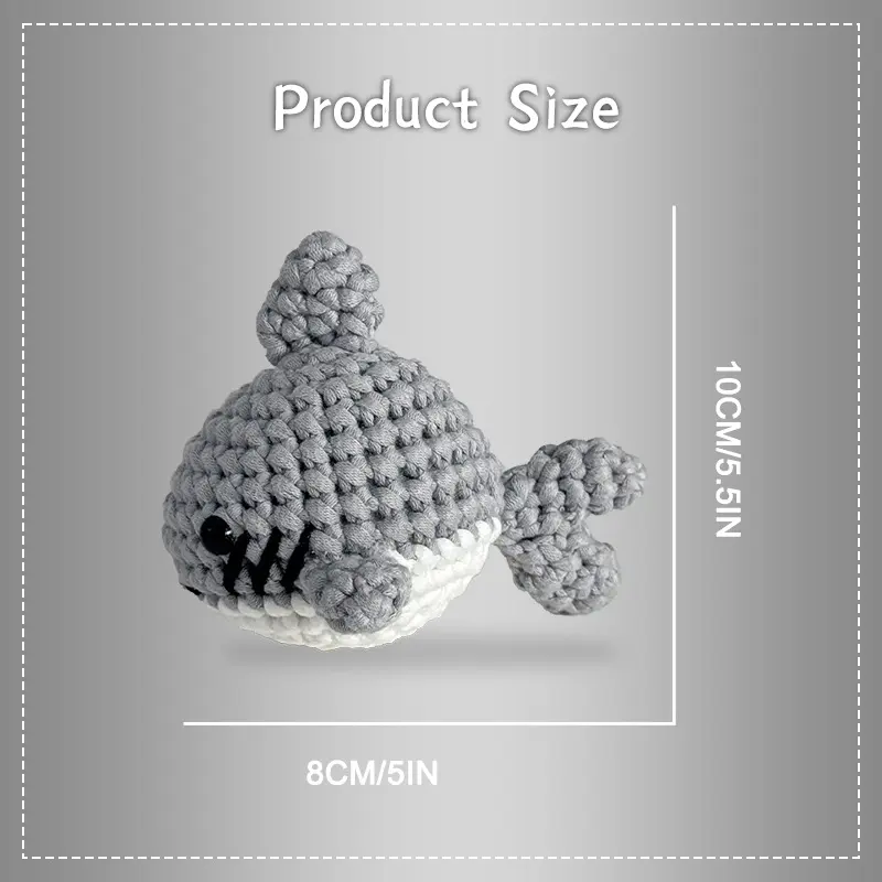 Complete gray shark crochet plush kit supplies on wooden table