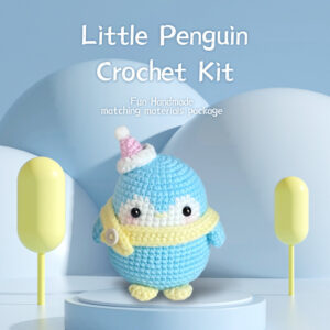 Complete blue christmas penguin crochet plush kit supplies on wooden table