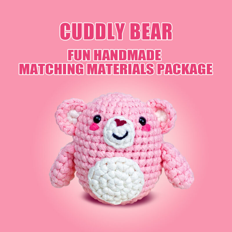 Complete pink bear crochet plush kit supplies on wooden table