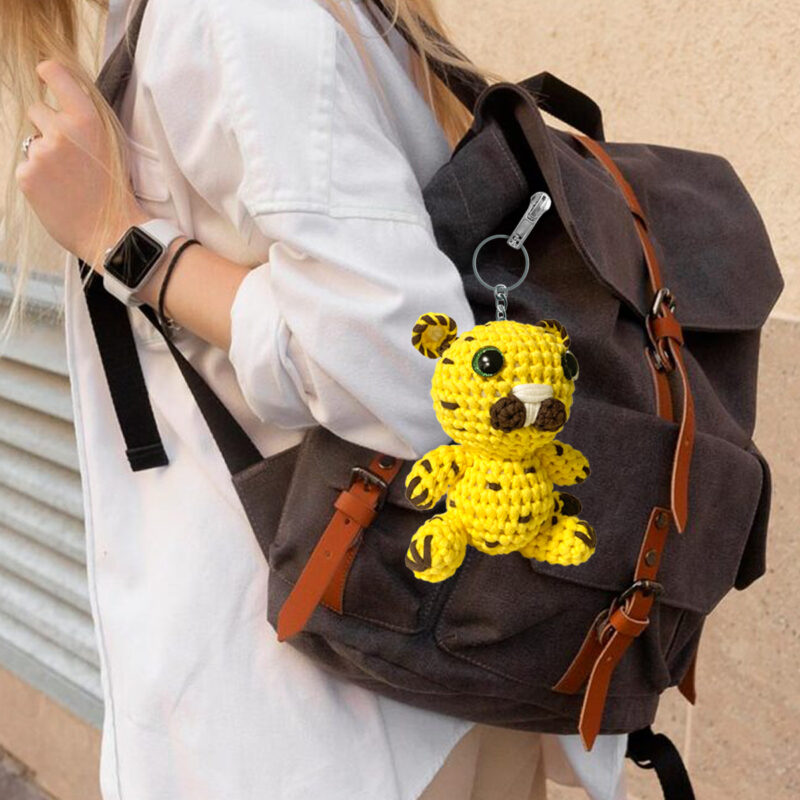 Small crochet leopard plush placed on a modern office desk