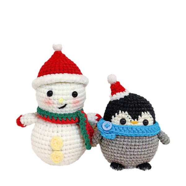 Two finished handmade holiday plushies displayed on Christmas mantel