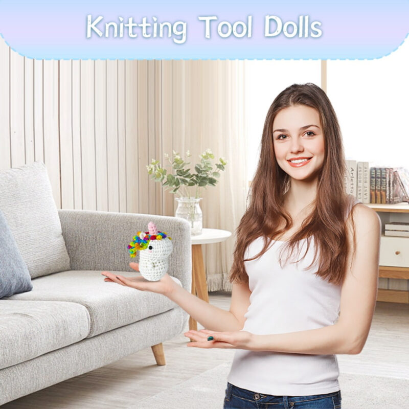 Small crochet pink unicorn plush placed on a modern office desk