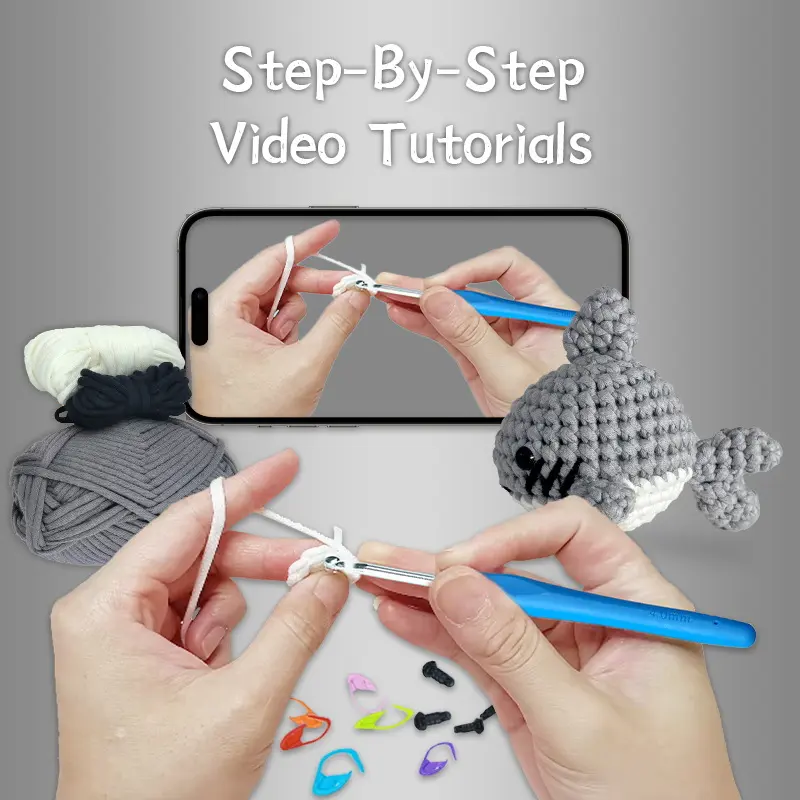 Small crochet gray shark plush placed on a modern office desk