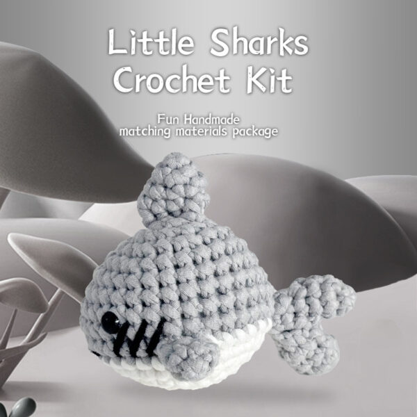 Complete gray shark crochet plush kit supplies on wooden table