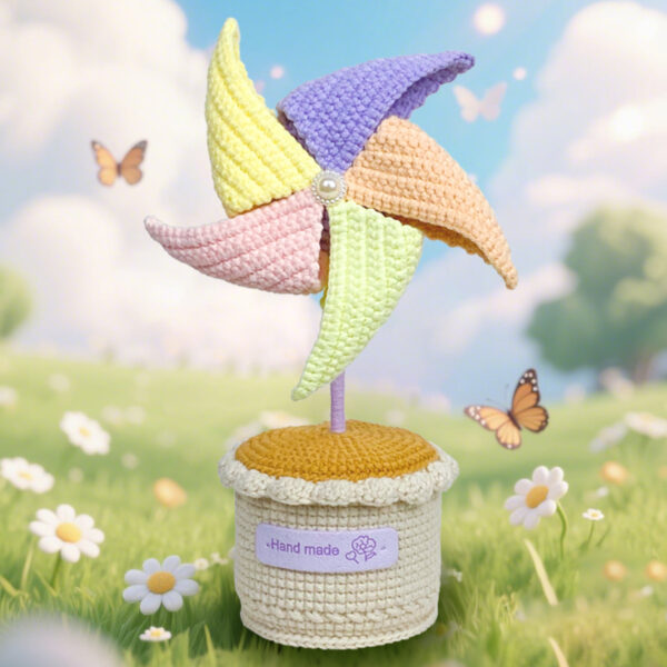 Small crochet potted pinwheel placed on a modern office desk