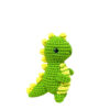 Finished handmade green dinosaur crochet plush displayed on nursery shelf