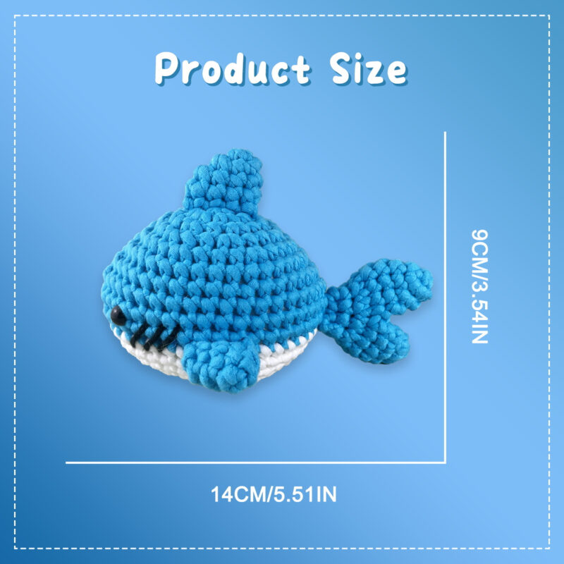 Complete blue whale crochet plush kit supplies on wooden table