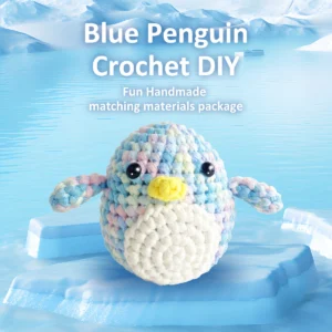 Complete penguin crochet plush kit supplies on wooden table