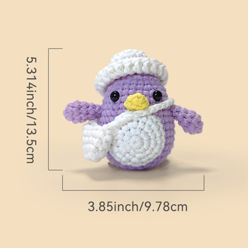 Small crochet purple penguin plush placed on a modern office desk